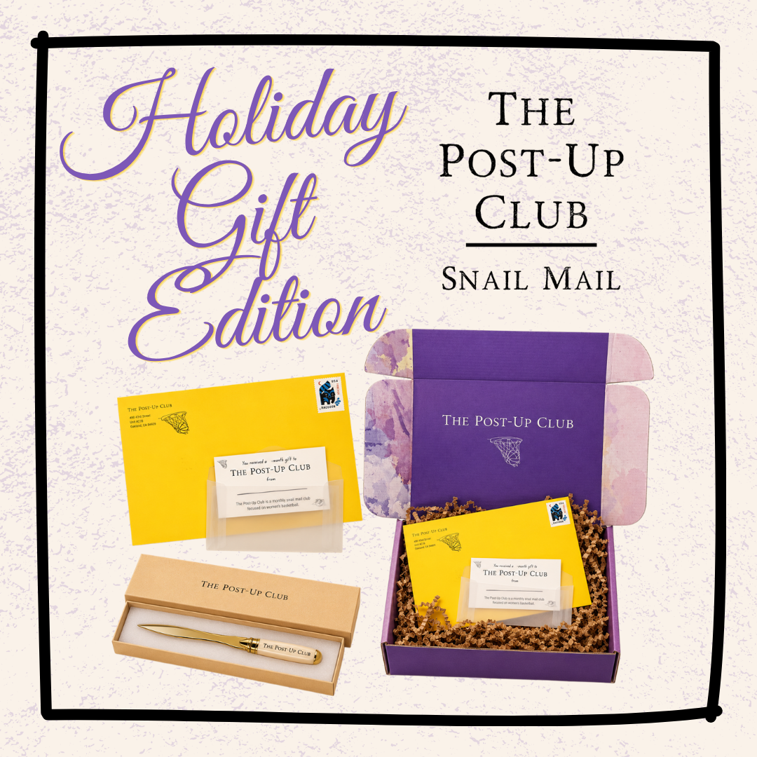 Holiday Gift Edition Snail Mail subscription box set by The Post-Up Club, featuring a purple branded box with shredded paper, yellow postcard envelopes, a wooden letterbox with a gold pen, and branded postcards on a cream background.